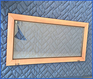 端が割れたガラスを床に置いている画像